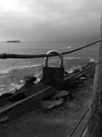 Close-up of padlock by sea