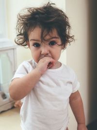 Portrait of cute boy eating at home