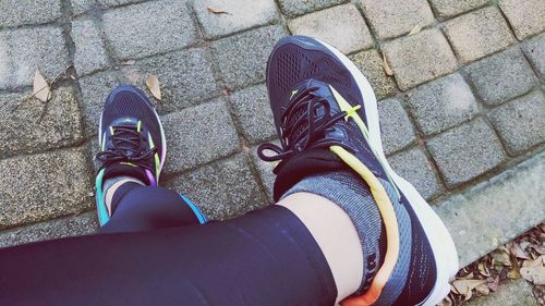 Low section of man standing on tiled floor