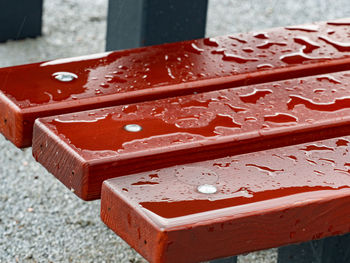 Raindrops on a bench, wet wooden boards. detail of polished wood