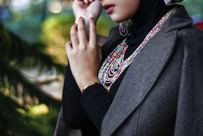 Midsection of woman standing against blurred background