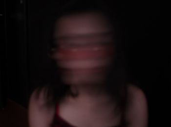 Close-up of woman hand against black background