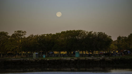 Scenic view of lake against clear sky at dusk