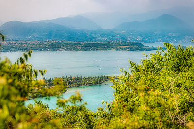 Scenic view of sea and mountains against sky