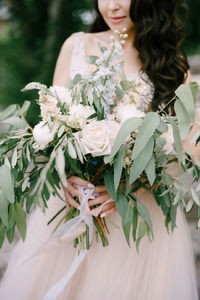 Close-up of woman with white flowers on plant