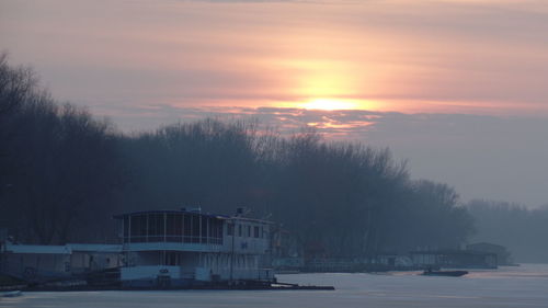 Scenic view of frozen lake against sky during sunset