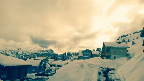 Houses against cloudy sky