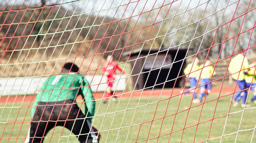 Rear view of man playing soccer