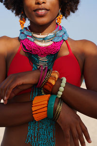 Portrait of a young black woman wearing colorful jewelry