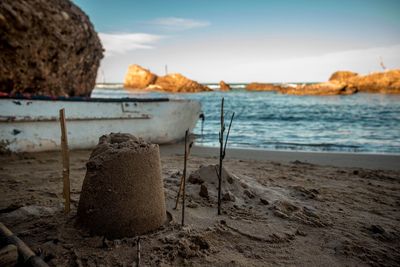 Sandcastle at beach against sky