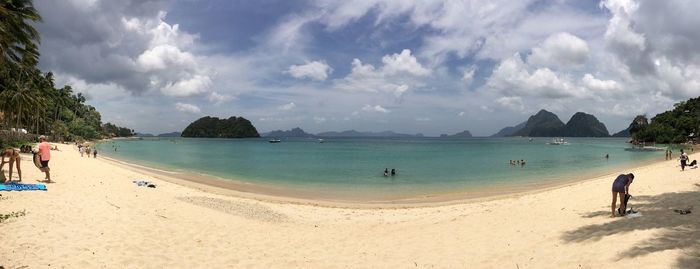 Panoramic view of beach against cloudy sky