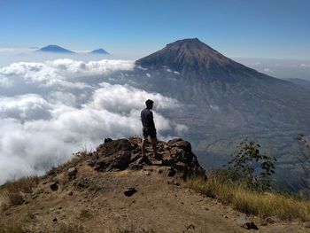 Man standing on mountain against sky