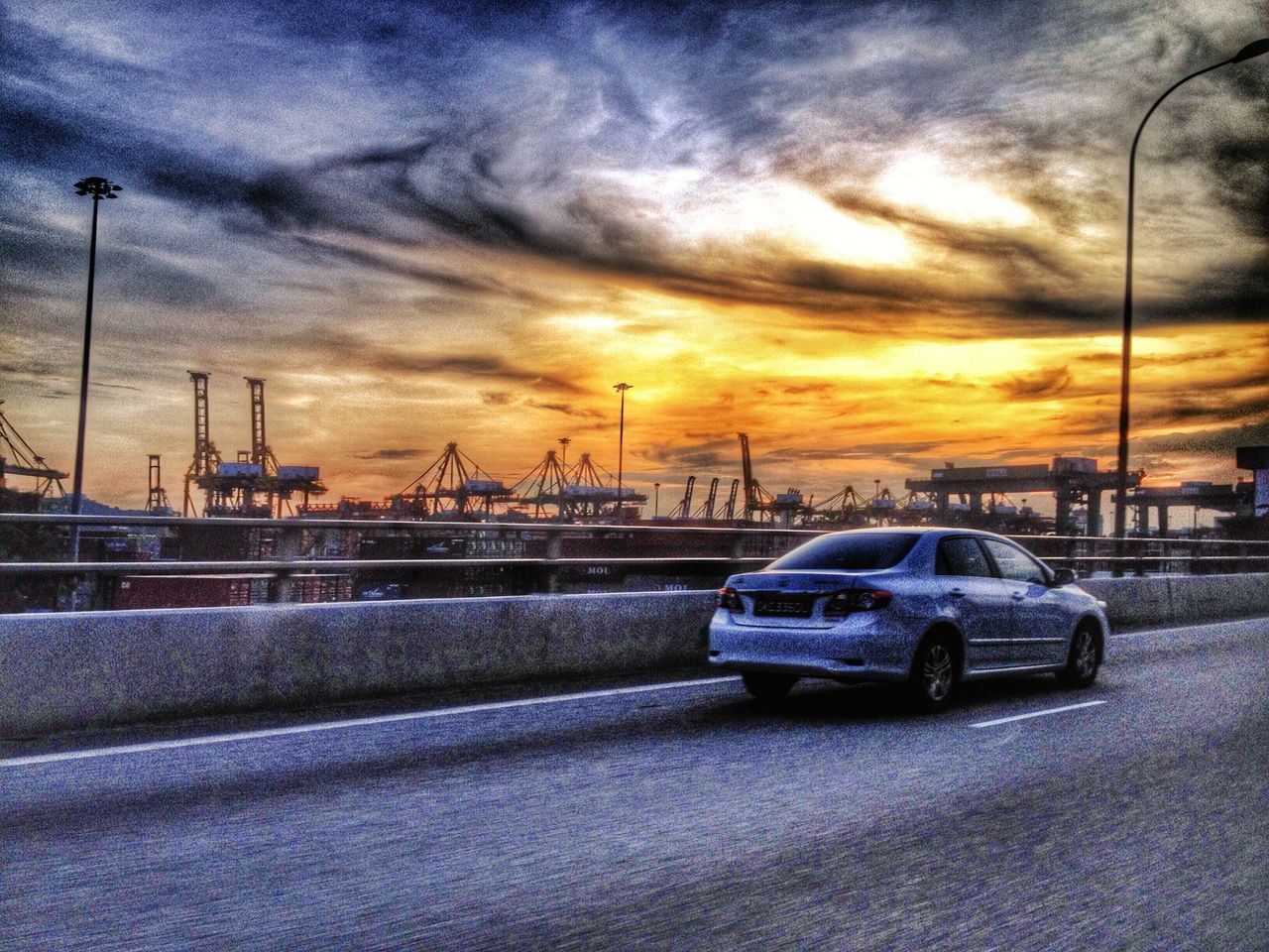 transportation, mode of transport, sunset, land vehicle, car, sky, cloud - sky, road, street, street light, weather, cloudy, orange color, nautical vessel, on the move, outdoors, cloud, travel, dramatic sky, stationary