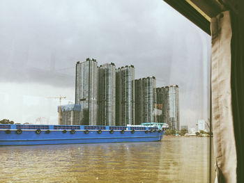 Modern building by sea against sky