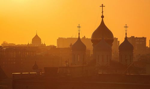 Silhouette church against clear sky during sunset