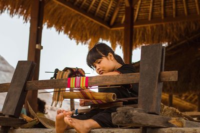 Rear view of girl sitting on seat