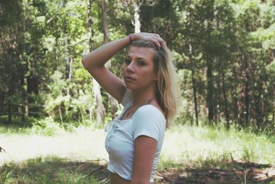 Young woman against trees