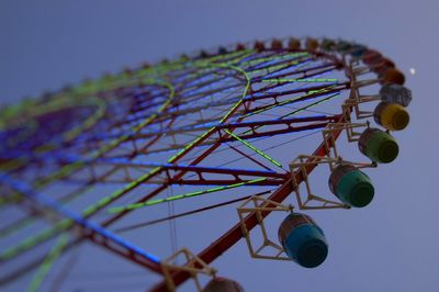 Low angle view of ferris wheel against sky