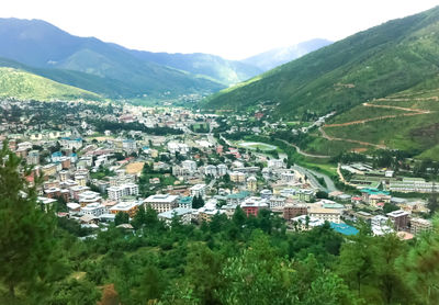 High angle view of houses and trees in city