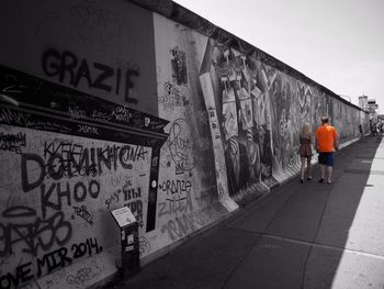 Full length of woman standing on wall