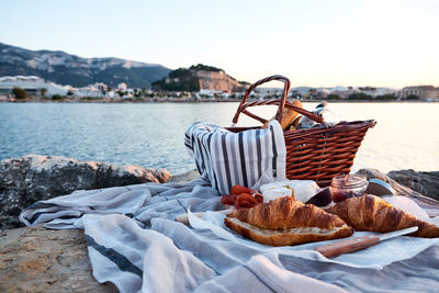 Close-up of food in basket by lake