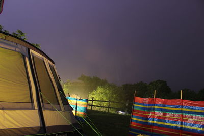 Multi colored tent on land against sky