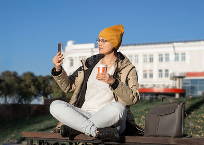 Side view of woman using mobile phone