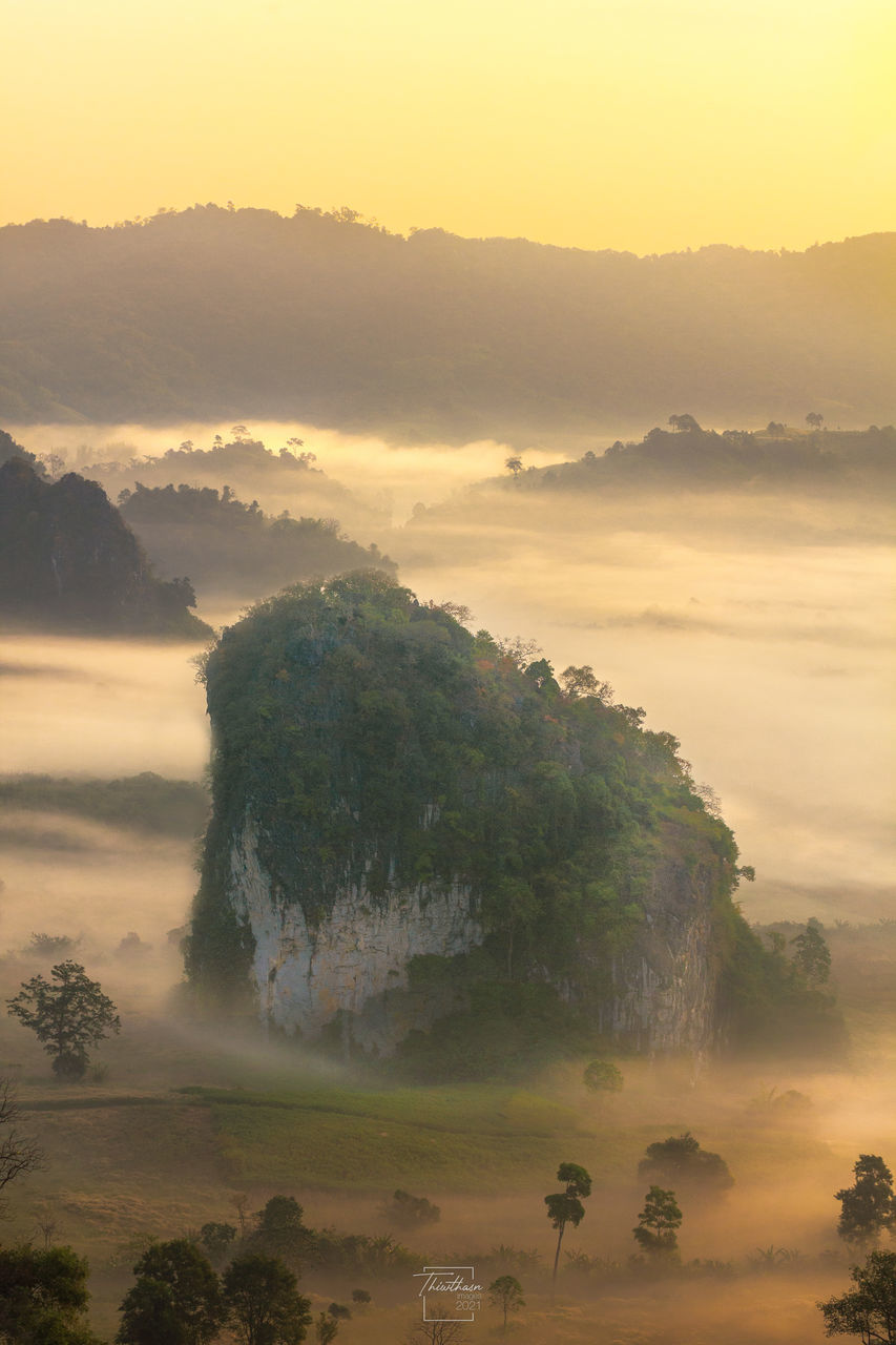 fog, environment, mist, morning, landscape, land, tree, sky, scenics - nature, nature, sunrise, beauty in nature, plant, dawn, mountain, sun, travel, cloud, horizon, forest, outdoors, social issues, sunlight, twilight, tranquility, haze, tourism, no people, travel destinations, water, rural scene, atmospheric mood, tropical climate, coast, sunbeam, sea, field, mountain peak, smog, vacation, holiday, idyllic, tranquil scene