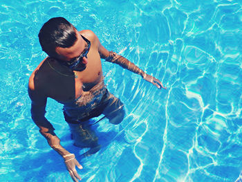 High angle view of shirtless man in swimming pool