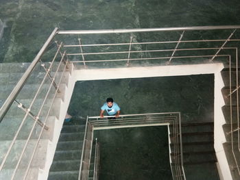 High angle view of man standing by railing