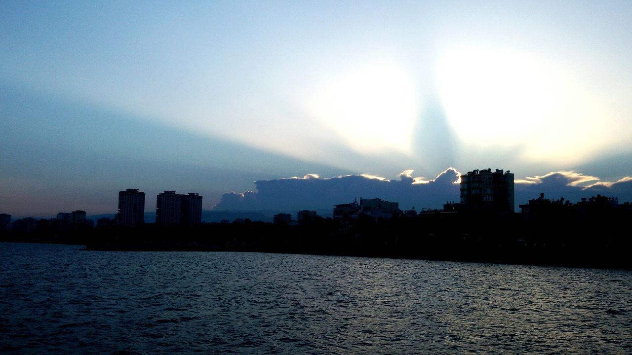 architecture, building exterior, built structure, waterfront, sky, cityscape, city, skyscraper, river, water, sunset, rippled, silhouette, cloud - sky, no people, outdoors, urban skyline, travel destinations, nature, beauty in nature, day