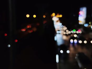 Defocused image of illuminated city at night