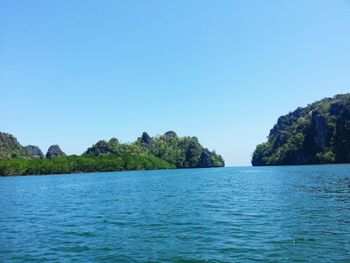 Scenic view of sea against clear blue sky