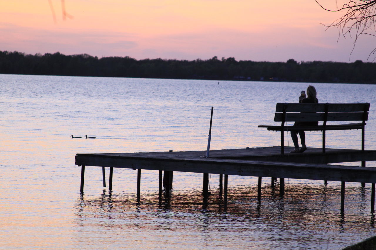 PIER ON LAKE DURING SUNSET