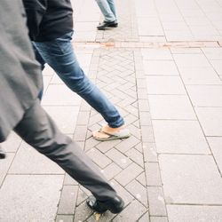 Low section of woman standing on tiled floor