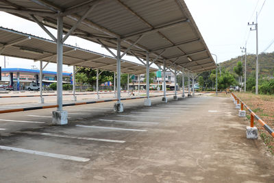 Empty railroad station platform against sky