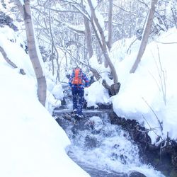 People on snow covered land during winter