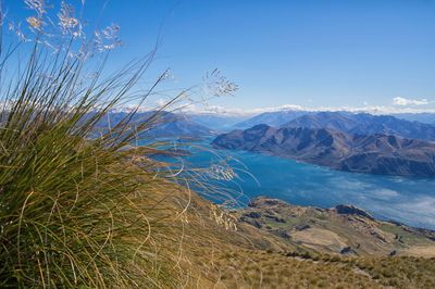 Scenic view of mountains against blue sky