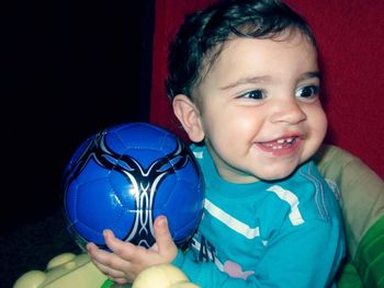 Portrait of happy girl holding toy