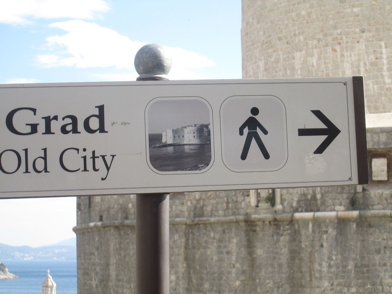 communication, text, sky, information sign, sunlight, human representation, day, no people, outdoors, sea, water, close-up, built structure, building exterior, architecture, road sign, nature