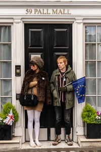 Friends standing on entrance of building