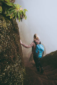 Rear view of woman moving down on steps