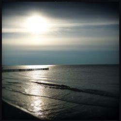 Pier on sea at sunset