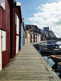 View of pier amidst buildings against sky