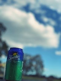 Close-up of water bottle against blue sky