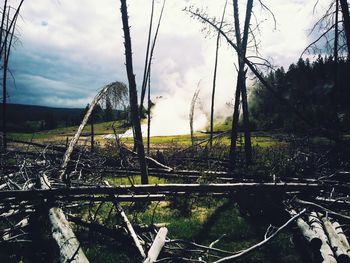 Fence on field against cloudy sky