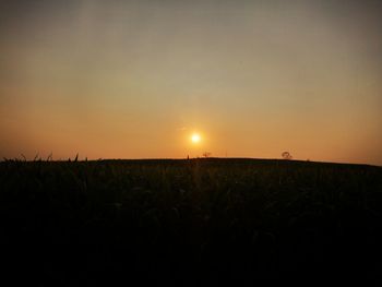 Scenic view of field against sky during sunset