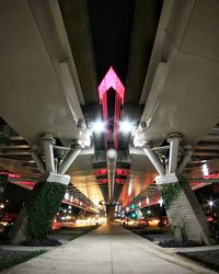 Low angle view of illuminated street lights at night