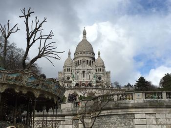 Low angle view of church against cloudy sky