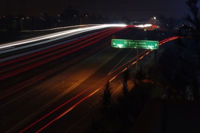 Light trails on road in city at night